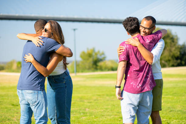 istock Happy friends standing on meadow and hugging. 1167145771