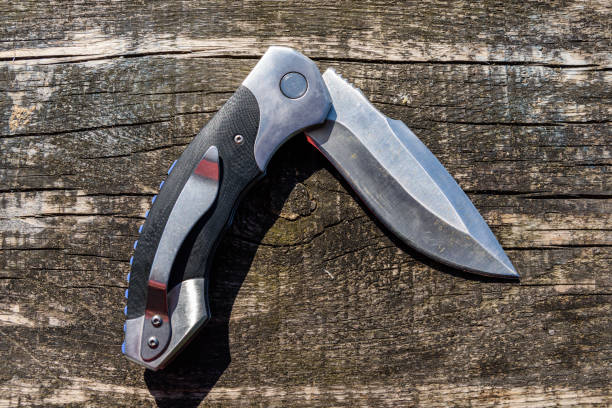 istock Folding knife on the rustic wooden background 1167146575