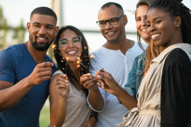 istock Happy young friends with sparklers 1167147406