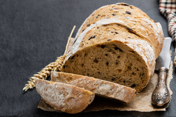 istock Homemade black olive loaf bread on black stone table 1167147620