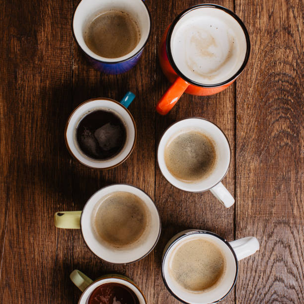 istock coffee in colored mugs on a wooden background, top view 1167152957