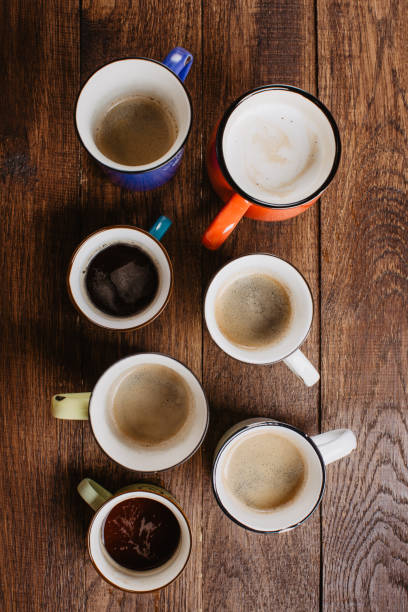 istock coffee in colored mugs on a wooden background, top view 1167153091