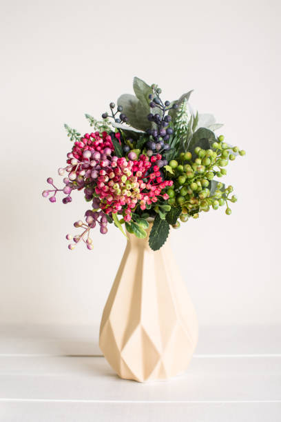 istock Artificial flowers in a vase on a white background 1167153270