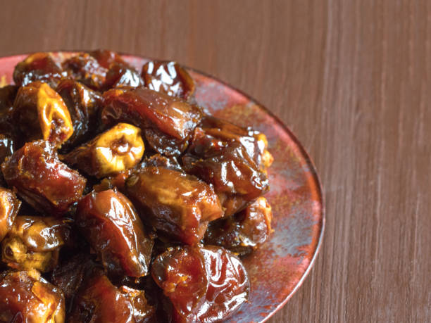 istock Delicious organic sweet dates in bowl with syrup. 1167154379