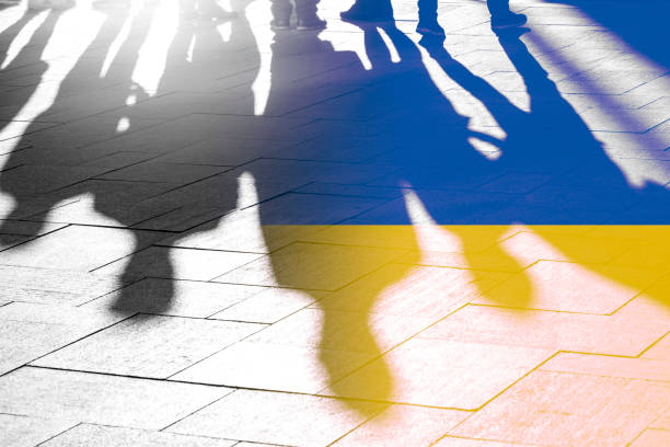 flag of ukraine and shadows of people, concept picture about independence, war, voting and right of people in country - ucrania imagens e fotografias de stock
