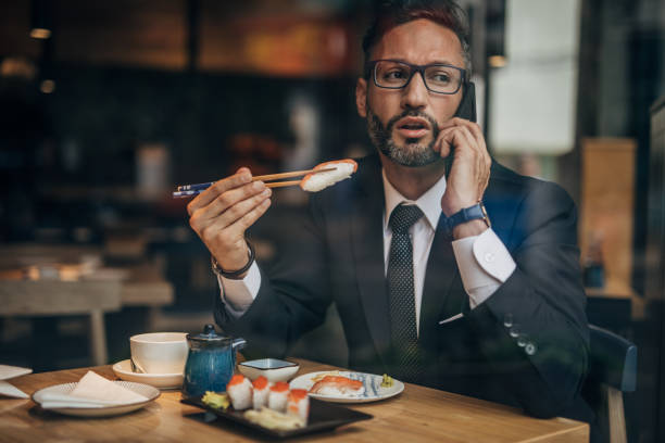 istock Businessman on lunch in sushi bar 1167156623