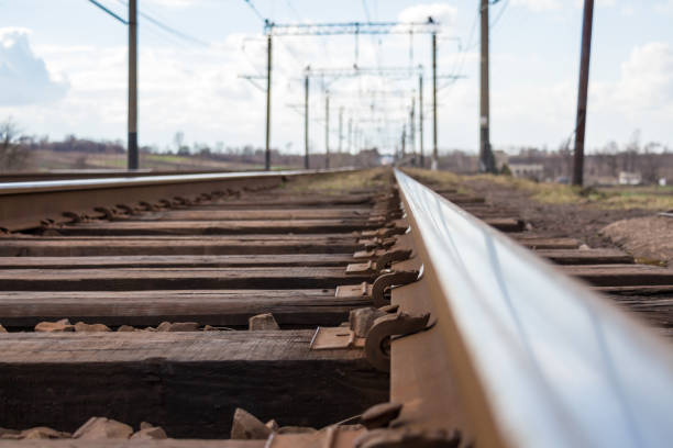 Railway with rails on wooden sleepers Close-up of railway rails on wooden sleepers. Smooth, mirrored surface rails on which trains often pass railroad track concrete railway sleeper thoroughfare stock pictures, royalty-free photos & images