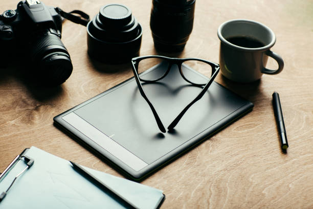 istock Photographer's desktop, camera, lens, graphics tablet, glasses 1167157655