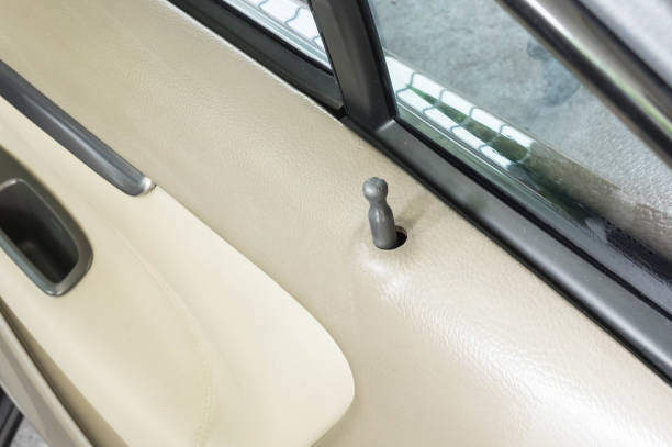istock 2000's luxury black car close up door lock button 1167159011
