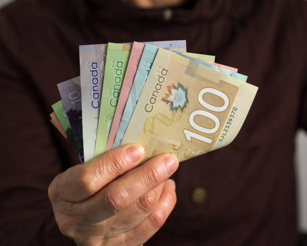 istock Midsection Of Man Counting Money 1167165049