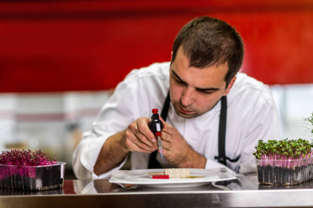 istock Chef using a small blow torch to add finishing glaze over a molecular cuisine dish 1167167677