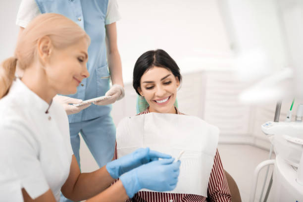istock Cheerful woman looking at teeth whitening samples. 1167171129