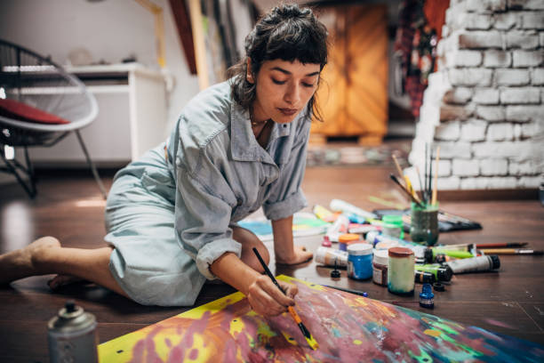 istock Lady painter painting on the floor at home 1167172760