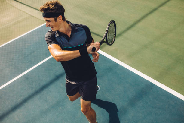 istock Tennis player playing on hard court 1167174189