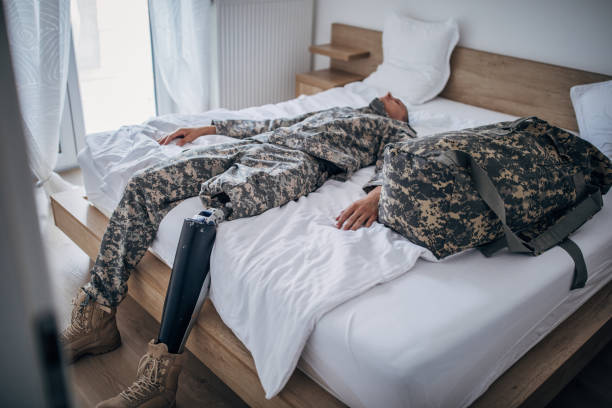 istock Disabled veteran soldier lying alone in bedroom 1167181107