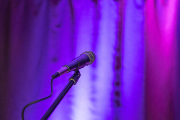 istock the microphone is turned on a multi-colored background, the background curtain is illuminated by different colored 1167181193