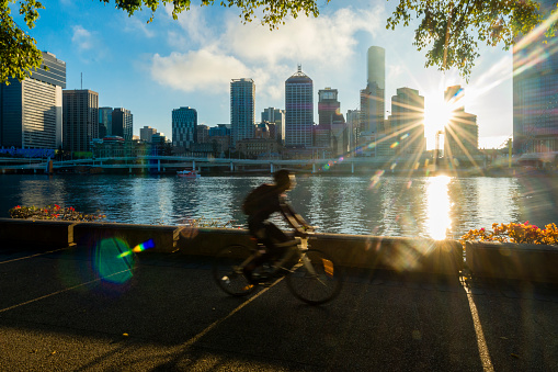 Brisbane, Australia - August 6, 2019: South Bank in Brisbane has extensive paths and tracks for running and cycling- and has the perfect view of Brisbane City during sunrise.