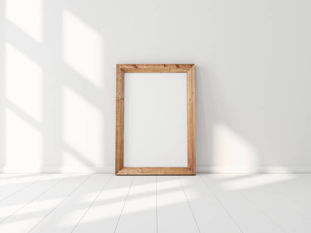 istock Vertical Wooden poster Frame Mockup standing near white wall 1167182612
