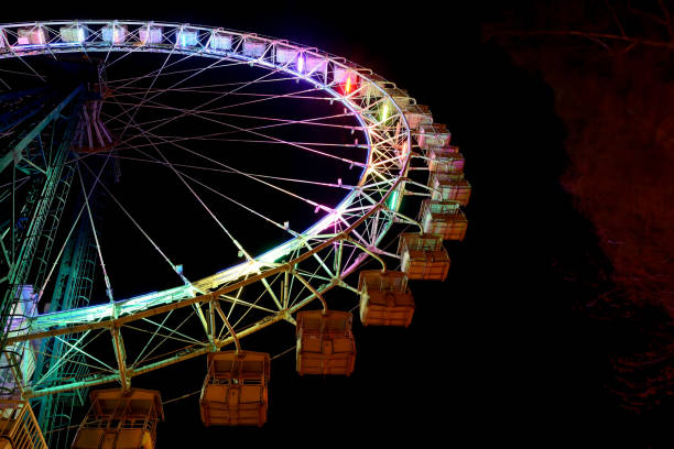 istock Part of ferris wheel with multicolor lighting at night. 1167182644