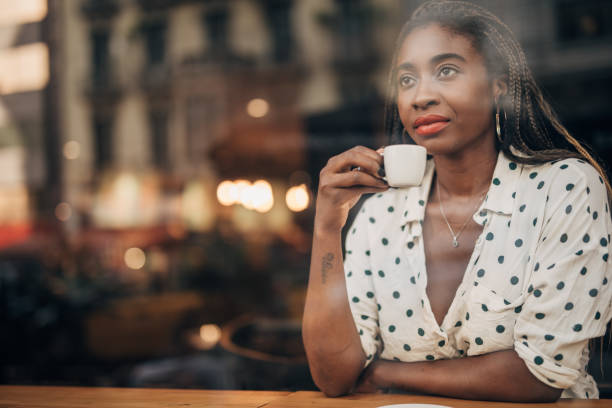 istock Black lady drinking coffee in cafe alone 1167184403