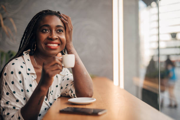 istock Black lady drinking coffee in cafe 1167184576