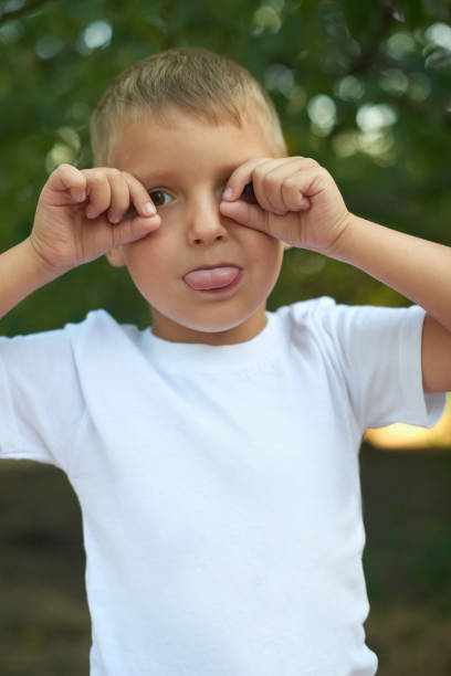 istock little boy has fun and shows tongue 1167185875
