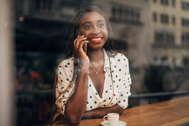 istock Black woman talking on mobile in cafe 1167185877