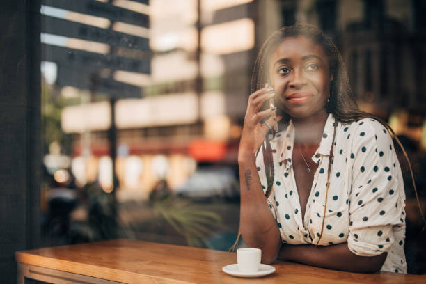 istock Black lady talking on mobile in cafe 1167185880