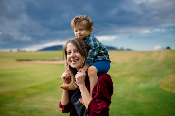istock mother have a fun with a son on a meadow in mountains 1167189284