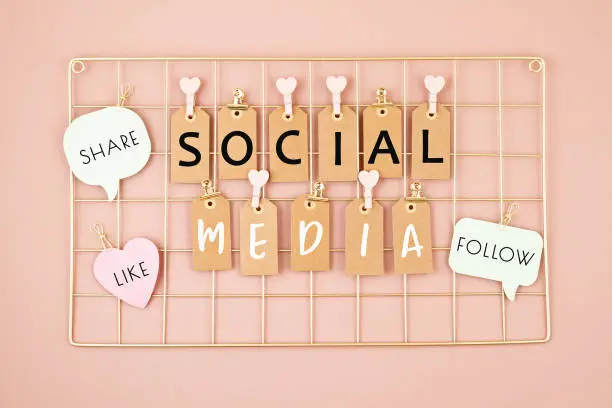 Social media text on the golden colored mesh board. Social networking concept