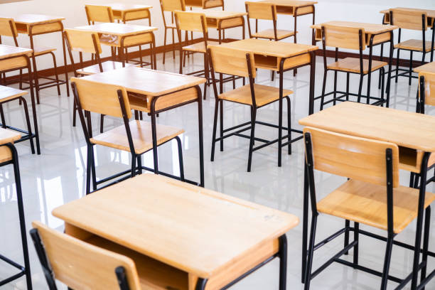 istock School empty classroom or lecture room interior with desks chair iron wooden whiteboard for studying lessons of secondary education in high school thailand. Learning and Back to school concept 1167190435