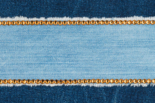 istock Two strips of rhinestones on denim. With space for design, text place. 1167190659