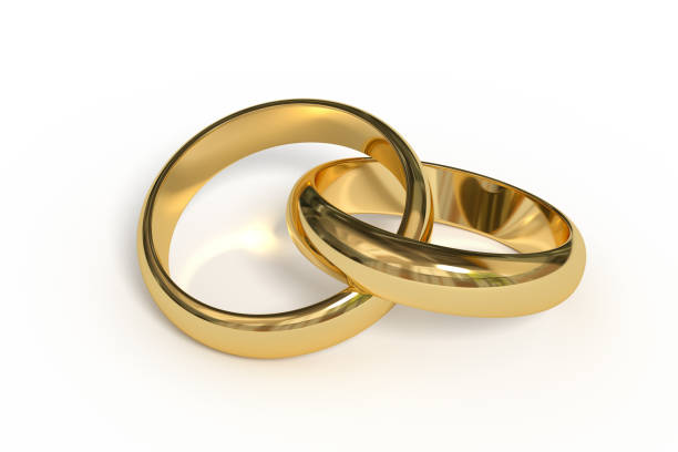 Two elegant wedding bands placed on a textured red wooden surface, creating a minimalist and romantic composition. The metallic rings cast subtle shadows, emphasizing their circular form against the rich burgundy background. Perfect for wedding, marriage, commitment, and love-themed designs.