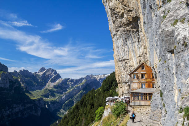 guest house aescher - wildkirchli against the ascher cliff at the mountain ebenalp - ascher imagens e fotografias de stock