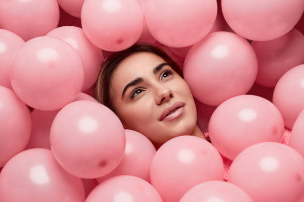 istock Dreamy female lying under balloons 1167195248