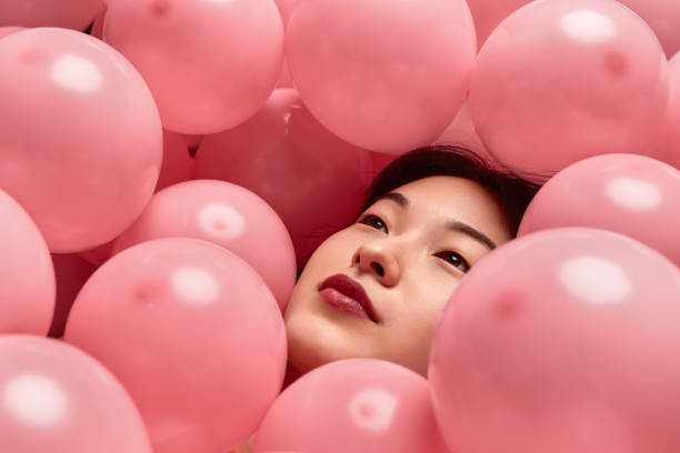 istock Dreamy Asian lady under balloons 1167195292