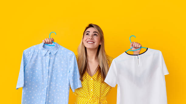 istock Smiling woman with clothes looking up 1167195333