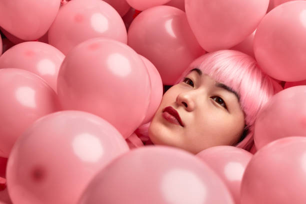 istock Pink balloons on Asian female 1167195400