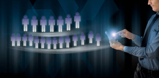 The freelancing concept against blue colored background i.e entrepreneur holding a cell phone with glow and no. of people standing for employment and work.With business teamwork concept also.
