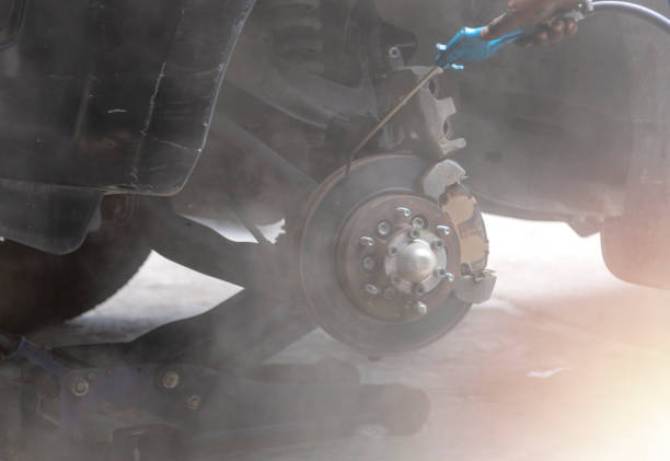 istock Mechanic use air gun clean disc break take dust removes before change break pat. 1167204109