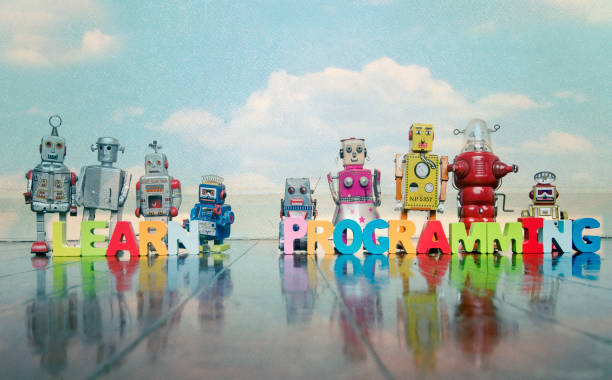 istock LEARN PROGRAMMING wooden letters and retro robot toys 1167204504