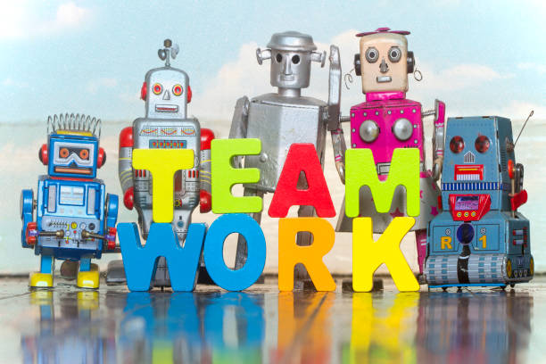 istock the word TEAM WORK  with wooden letters and 5 retro bots 1167204531