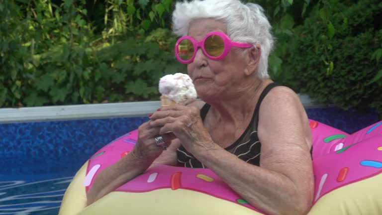 Portrait of Senior Woman Enjoying Ice Cream by the Pool Summer Festive Attitude