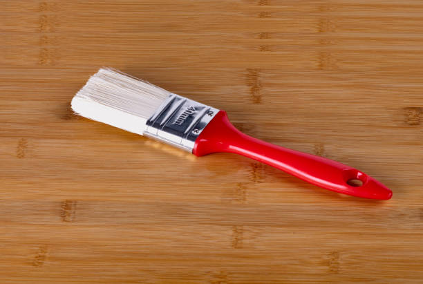 istock tassel with red handle lies on a wooden board 1167212220