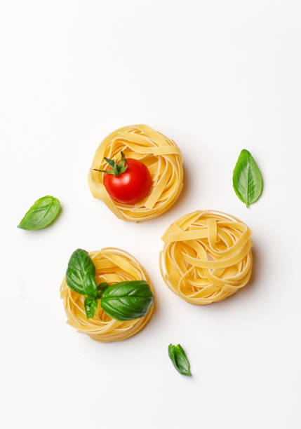 istock Various uncooked pasta on white background. Top view. Raw pasta with ingredients for cooking. Food concept 1167213500