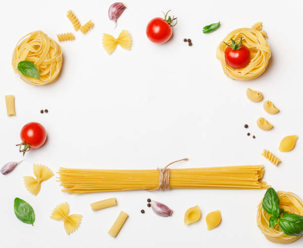 istock Various uncooked pasta on white background. Top view. Raw pasta with ingredients for cooking. Food concept 1167213633