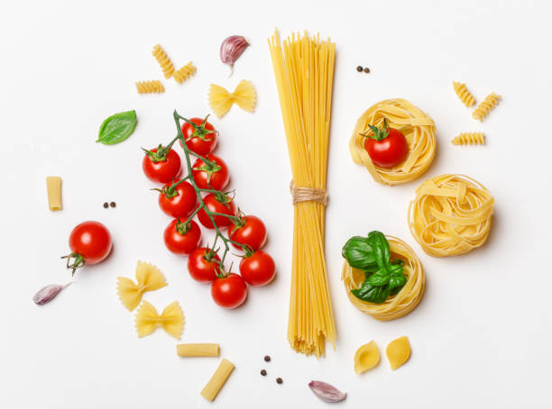 istock Various uncooked pasta on white background. Top view. Raw pasta with ingredients for cooking. Food concept 1167213674