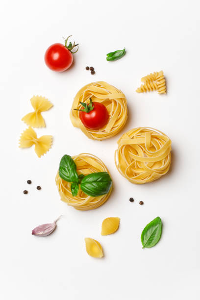 istock Various uncooked pasta on white background. Top view. Raw pasta with ingredients for cooking. Food concept 1167213678