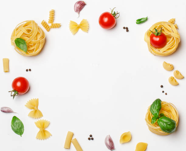 istock Various uncooked pasta on white background. Top view. Raw pasta with ingredients for cooking. Food concept 1167213686