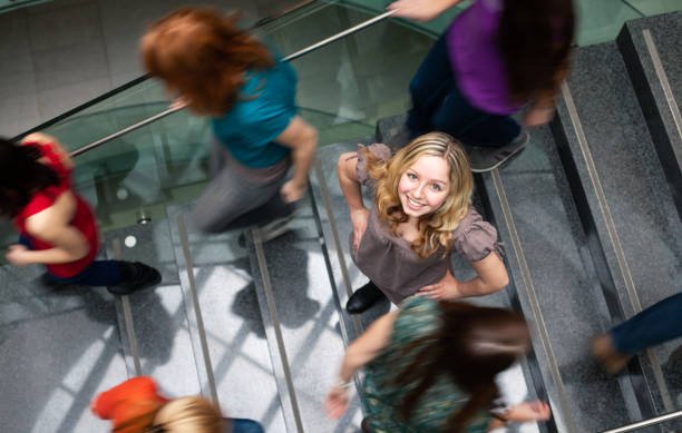 istock Students rushing up and down a busy stairway 1167215444